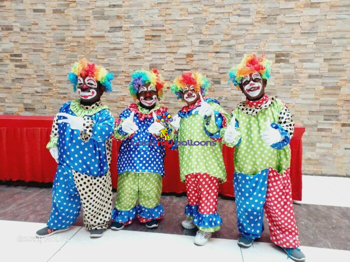 Dwarf Clown entertainer in colorful costume performing magic tricks, juggling, and face painting at a children’s birthday party in Bangalore.